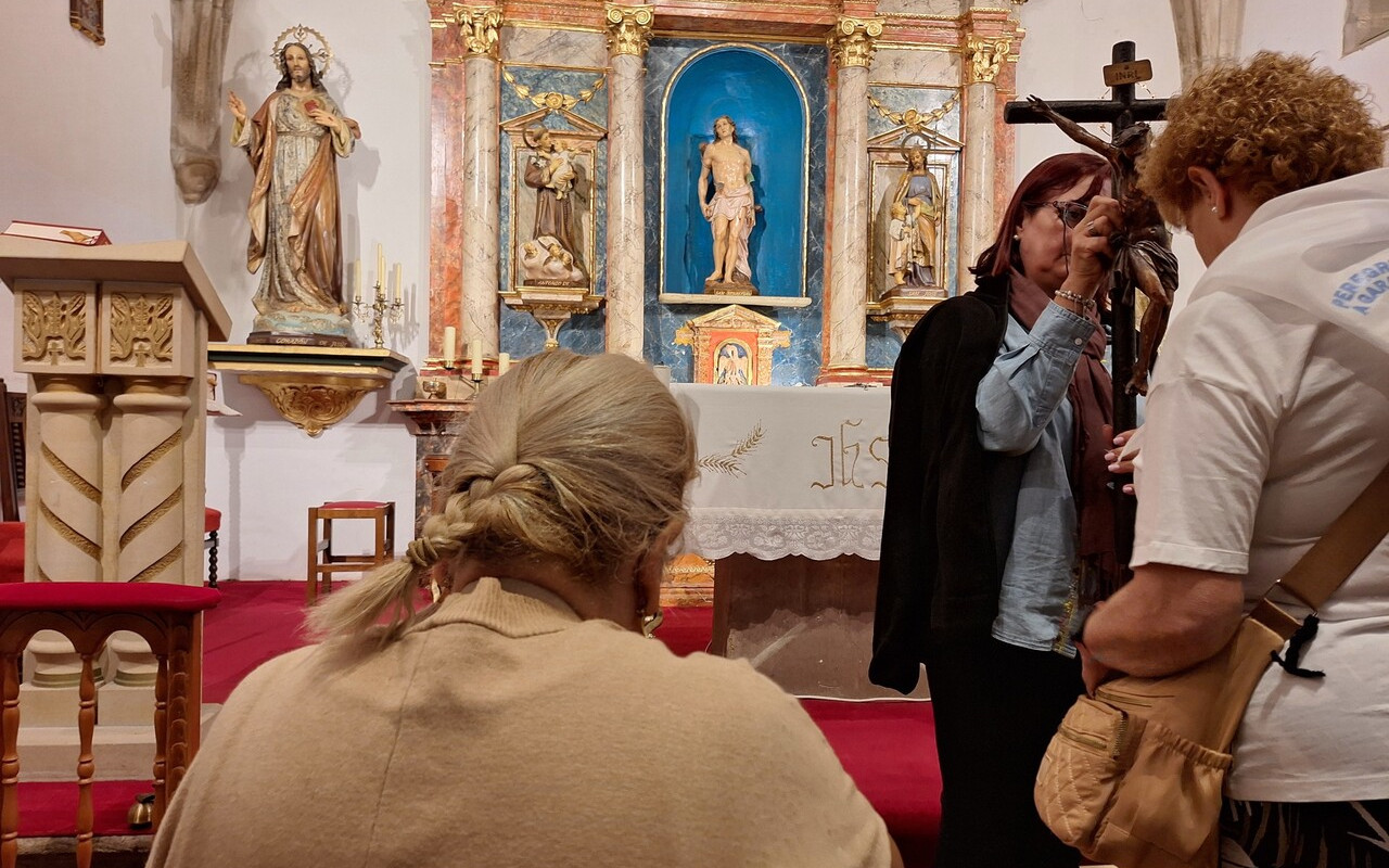 Mujer rezando en el interior de la Iglesia de San Sebastián.