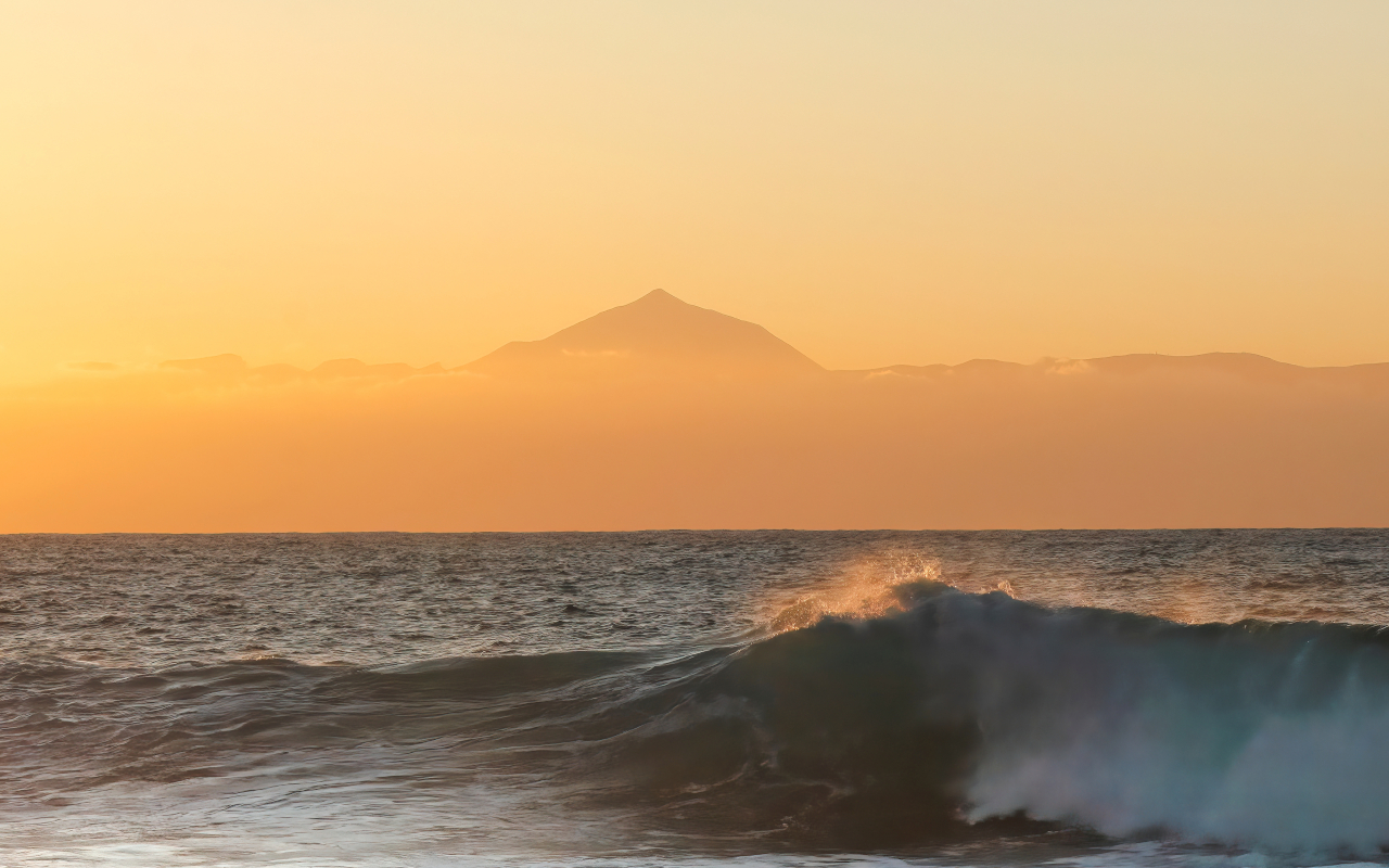 Teide on the horizon above the sea from another Island.