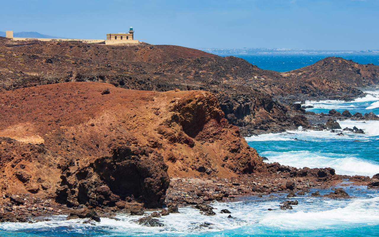 Views of the islet of Lobos, with the waves breaking the landscape.