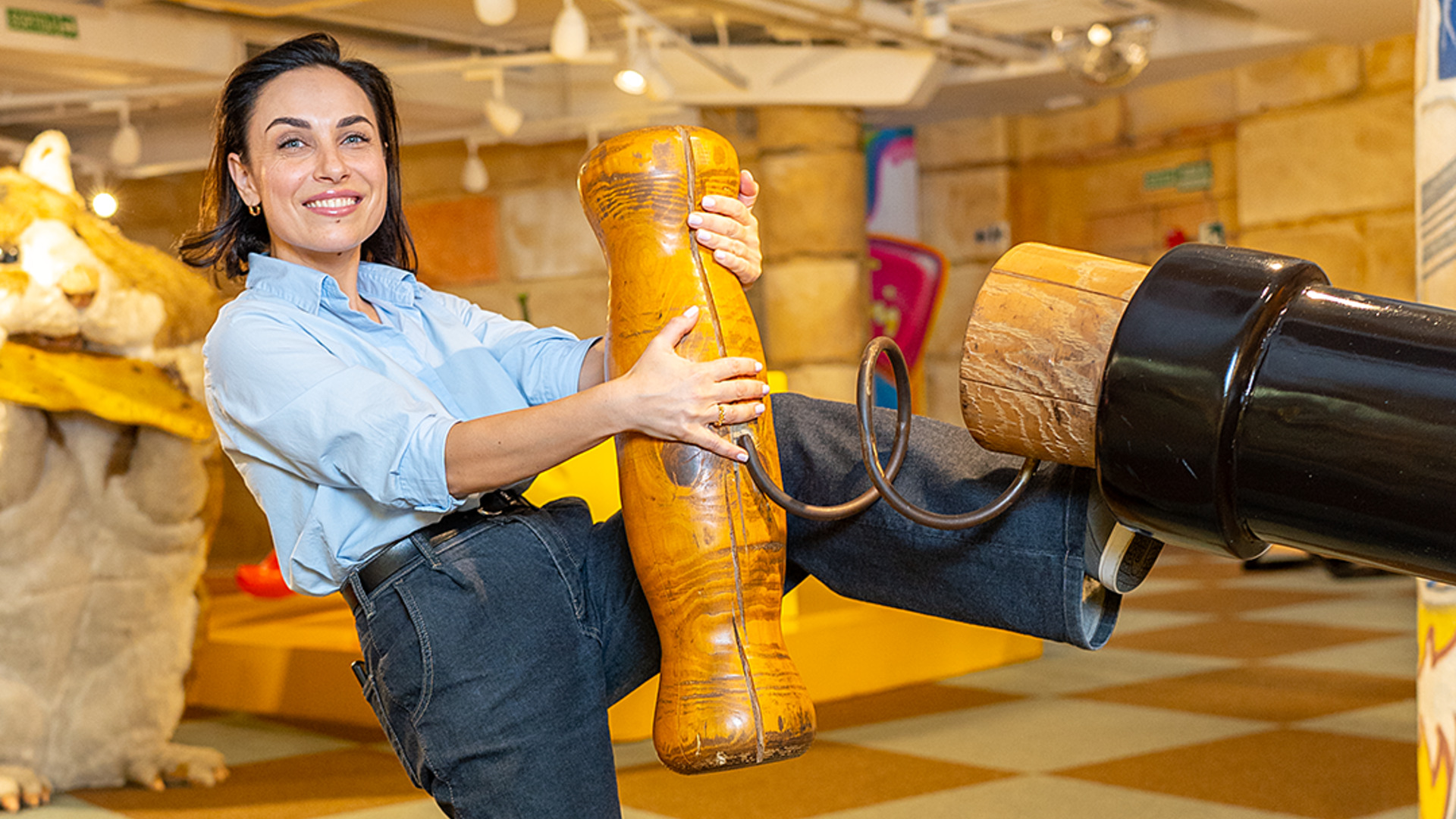 Mujer posando con objetos gigantes de madera en Big Fun Museum Barcelona