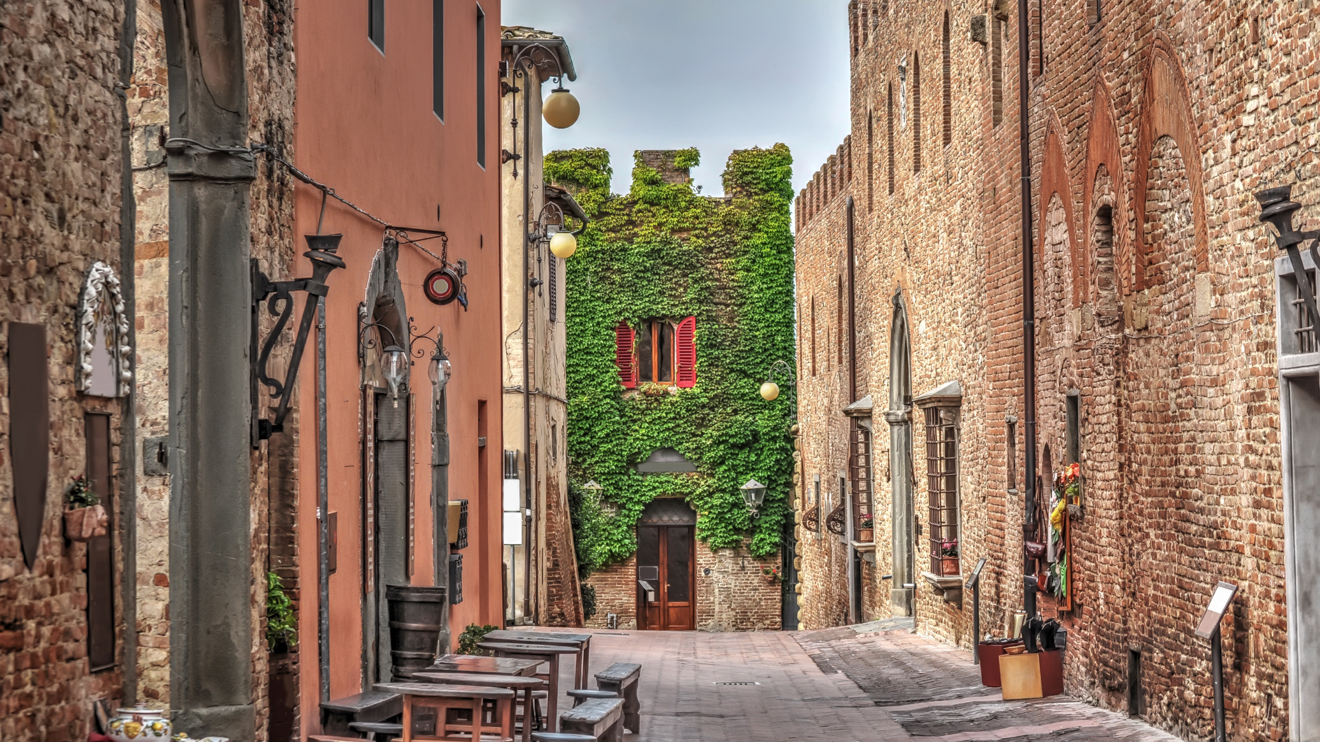 Calle medieval con casas de piedra y hiedra en la Toscana, Italia
