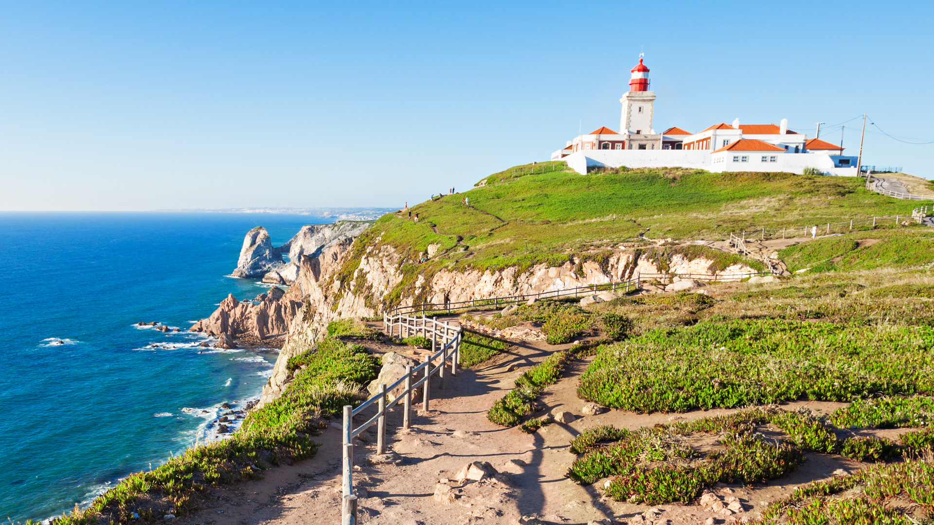 Acantilados del Cabo da Roca con su faro sobre el océano en un día despejado.