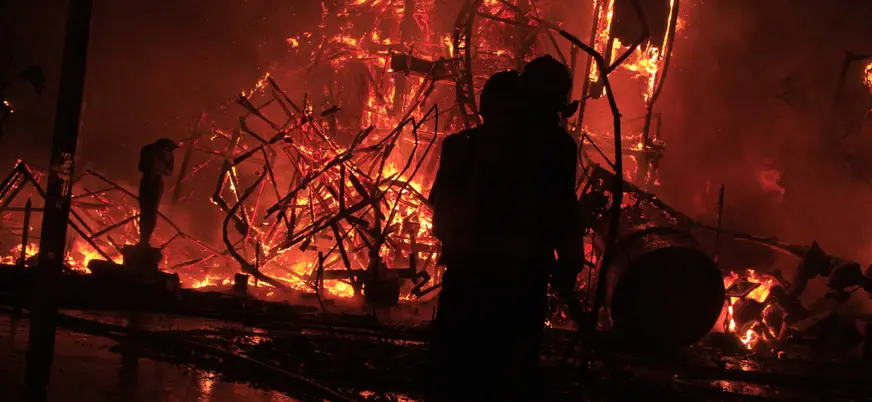 Bomberos ante una recreación del incendio de Santander entre llamas intensas