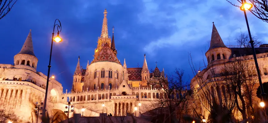 La iluminada Iglesia de Matías y el Bastión de los Pescadores en Budapest de noche.