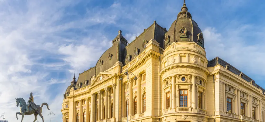 La Plaza de la Universidad con la estatua ecuestre de Carol I y la Biblioteca Central de Bucarest.
