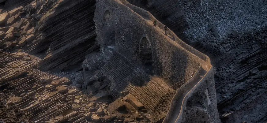Escaleras de piedra en San Juan de Gaztelugatxe sobre formaciones rocosas junto al mar.