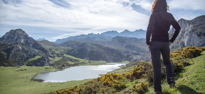 Mujer observando el lago de Covadonga en los Picos de Europa, Asturias