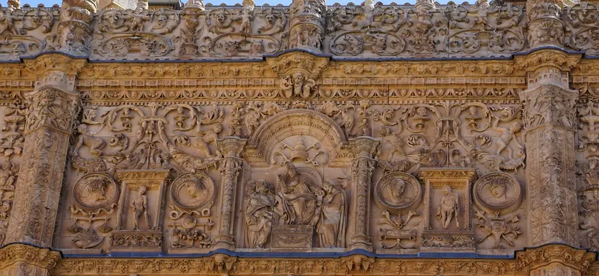 Detalle de la fachada plateresca de la Universidad de Salamanca, repleta de relieves y esculturas históricas.