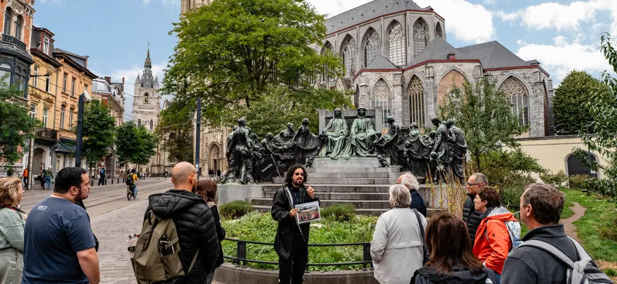 Guía de buendía explicando el monumento a los hermanos Van Eyck, Gante