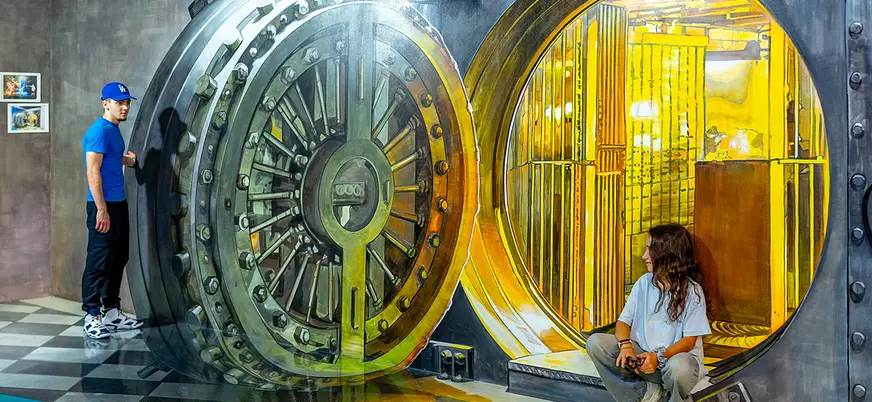 Personas en ilusión de caja fuerte gigante en Museum of Illusions Barcelona