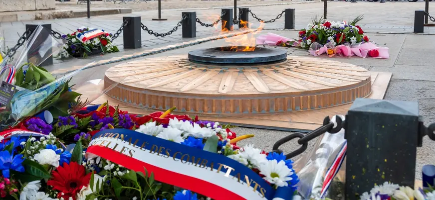 Llama eterna en la Tumba del Soldado Desconocido con flores en el Arco del Triunfo