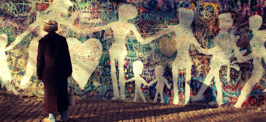 Persona mirando el Muro de John Lennon en Praga