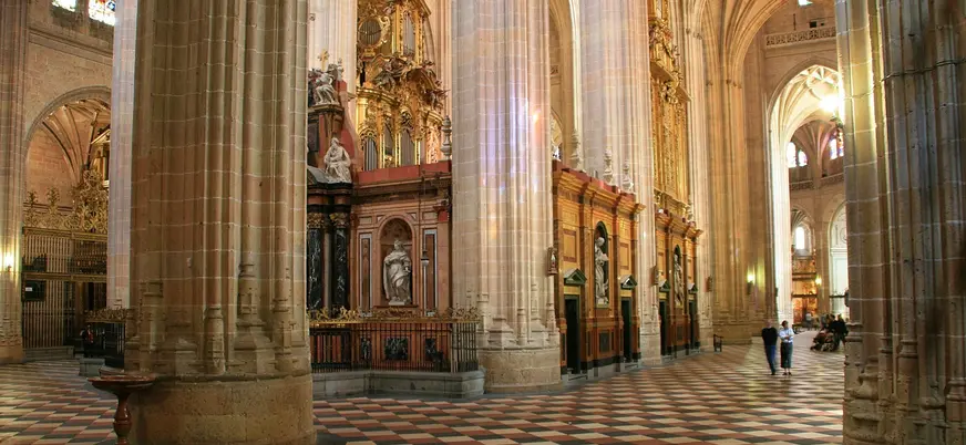 Interior gótico de la Catedral de Segovia con grandes columnas y retablos