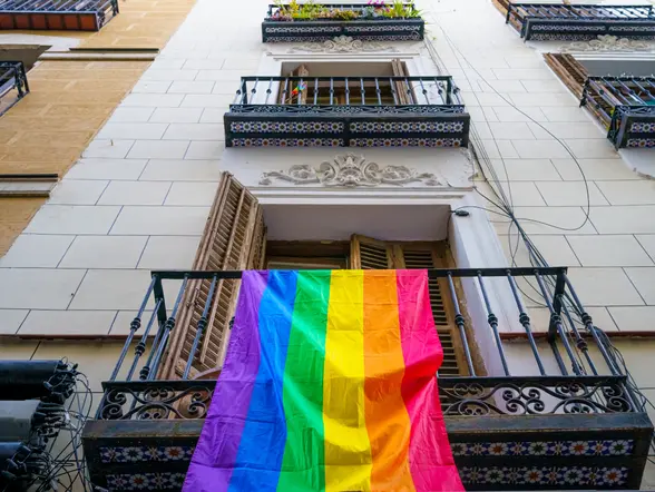 Fachada de un edificio con la bandera que representa los derechos LGTBI.