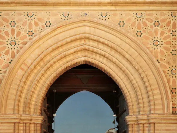 Vista de los elementos de arte mudéjar en el Monasterio de San Isidoro del Campo, con intricados motivos decorativos que combinan influencias cristianas y musulmanas.