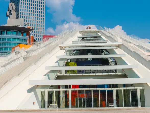 Vista de la Pirámide de Tirana, destacando su estructura inconfundible y su diseño futurista, rodeada de la ciudad.