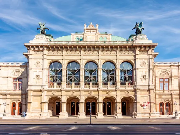 Fachada de la Ópera Estatal de Viena bajo un cielo azul.